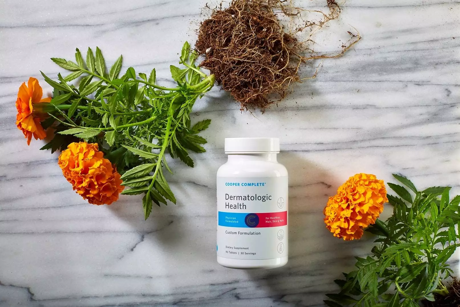 Cooper Complete Dermatologic Health dietary supplement bottle on a marble surface with marigold plants. Picture of Cooper Complete Hair Skin and Nails Supplement Dermatologic Health Bottle on a marble surface with marigold flowers