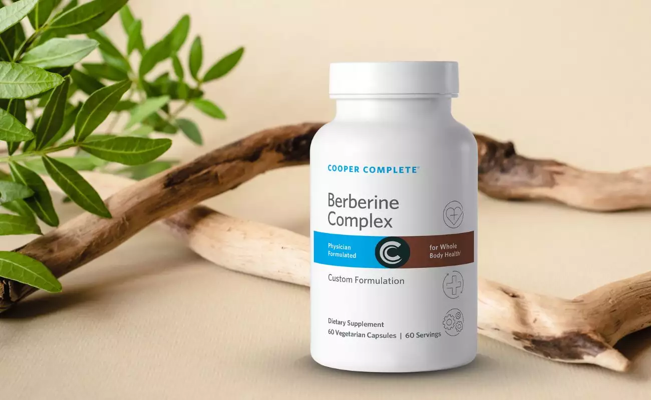 Photo of Cooper Complete Berberine Supplement bottle surrounded by organic wood and greenery