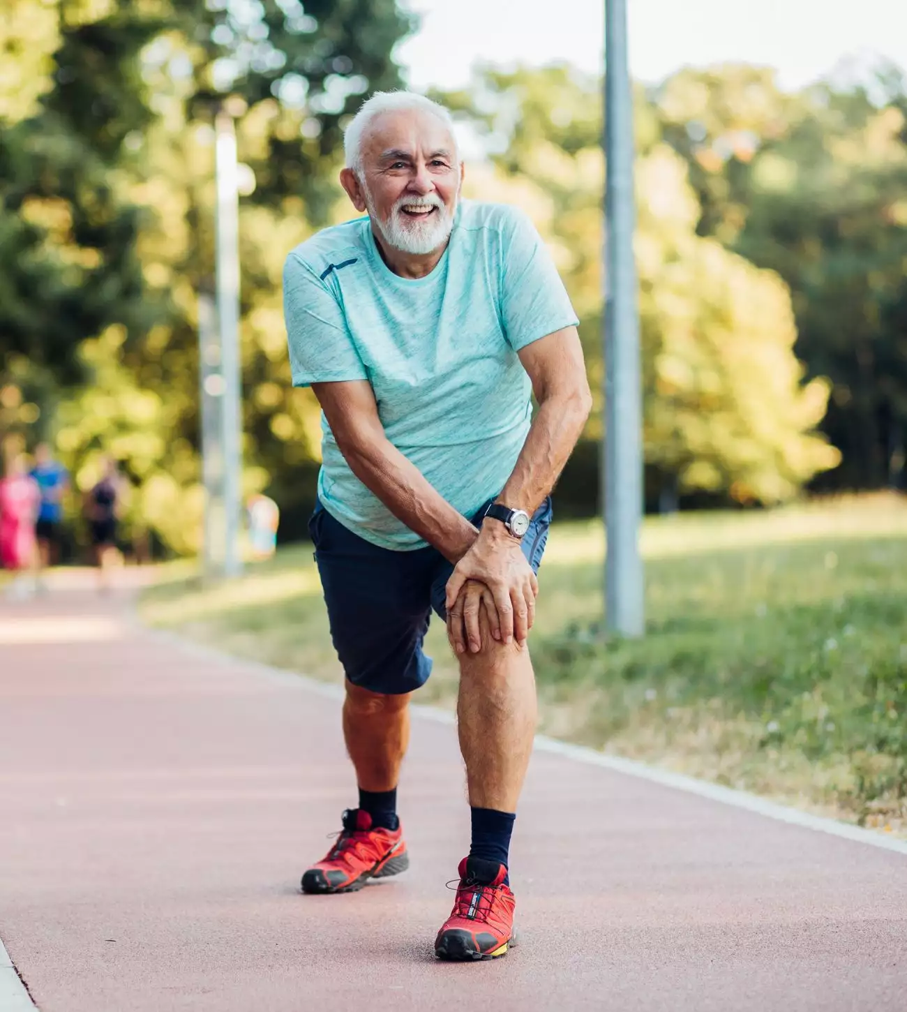 Photo of a mature man stretching on a jog.