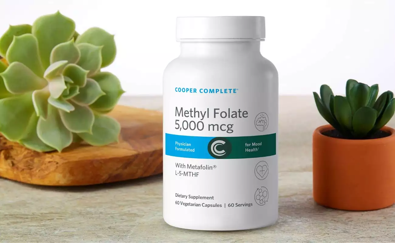 Photo of Cooper Complete Methy Folate 5000 mcg (5 mg) Supplement bottle and succulent plants. Support your mental health and well being with methyl folate supplement 5 mg