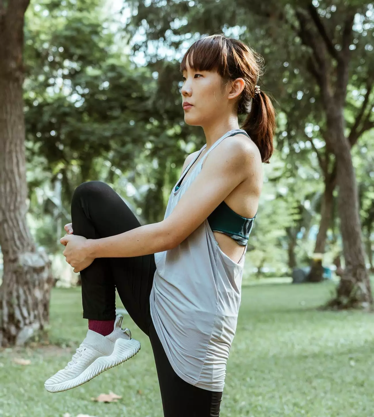 Photo of a young woman stretching in the park - Each vegetarian capsule of Cooper Complete chelated Iron Bisglycinate Supplement contains 29 mg of elemental iron that's well tolerated and easily absorbed.
